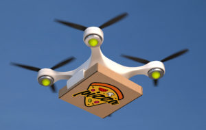 Air drone carrying single pizza box.